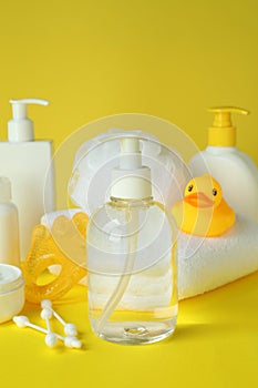 Different baby hygiene accessories on yellow background