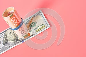 Different banknotes on pink background. Payment of pensions, salaries