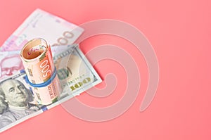 Different banknotes on pink background. Payment of pensions, salaries