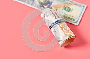 Different banknotes on pink background. Payment of pensions, salaries