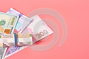 Different banknotes on pink background. Payment of pensions, salaries