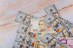 Different banknotes Ukrainian national currency bills and American dollars money and finances investment concept