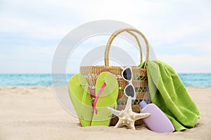 Different beach objects and starfish on sand near sea
