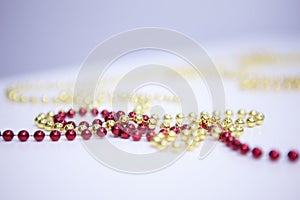 Different beads necklaces on white wooden table. Holiday. Christmas. New Year. different colors - red, yelow