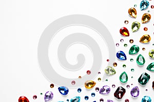 Different beautiful gemstones on white background