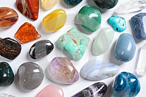 Different beautiful gemstones on white background