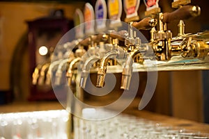 Different beer taps in a row