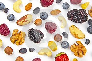 Different berries and nuts on a white background. vitamin proteins and healthy foods