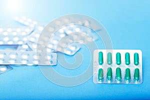 Different blister of pills. Medical and Global healthcare concept. Pharmaceutical industry. Light blue background with