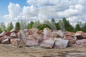 Different blocks of red granite with flat and torn edges