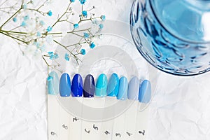 Different blue nails polish manicure palette Background.