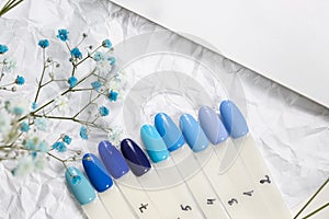 Different blue nails polish manicure palette Background.