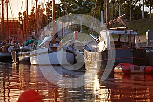 Different boats at the pier at dawn