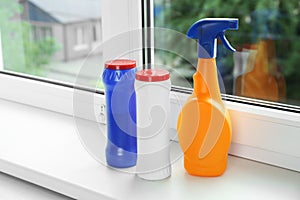 Different bottles of cleaning products on windowsill