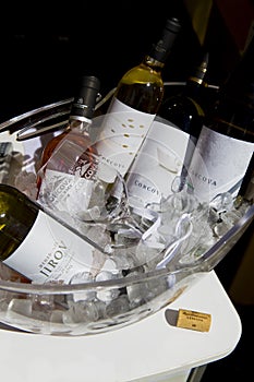Different bottles of wine in a bole with ice photo