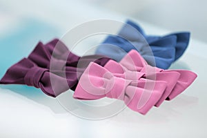 Different bow ties on glass background