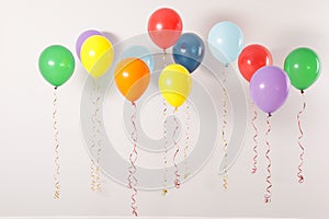 Different bright balloons on light background