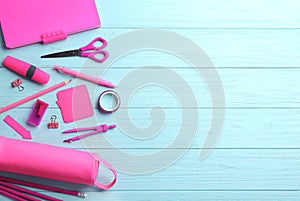 Different bright  stationery on light blue wooden background, flat lay. Space for text