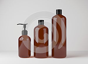 Different brown glass bottles for hair and body care products 3D render, set of cosmetic containers on gray studio