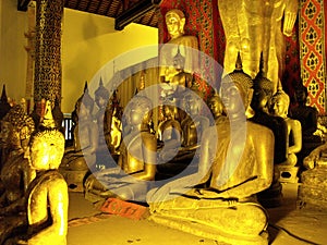 Different Buddha images in the main hall of Wat Intakhin Pillar Vihara Temple in Chiang Mai photo