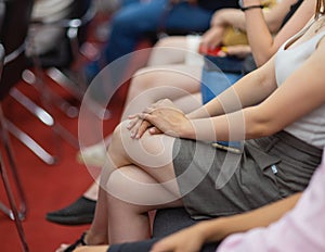 Different business people sitting in row, men and women waiting in queue line for job interview with lady in high-heeled