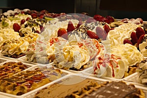 Different cakes with fruit and cream