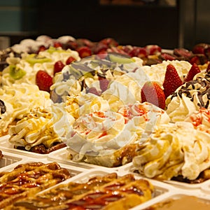 Different cakes with fruit and cream