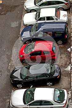 Different cars parked in a parking line 