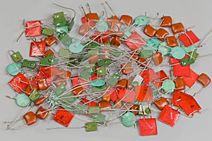 Different ceramic and film fixed capacitors on a gray surface