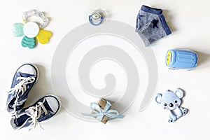 Different child toys, car, gift box on white table with copy space, flat lay. Baby shower, accessories, decorations