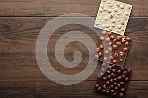 Different chocolate bars with whole hazelnuts