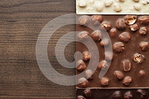Different chocolate bars with whole hazelnuts
