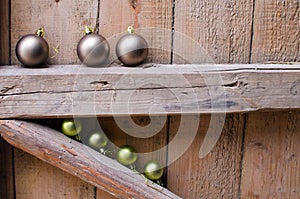 Different Christmas balls on old wooden background wall.