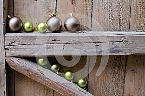 different Christmas balls on old wooden background wall.