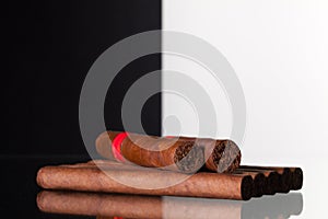 Different cigars on a glass table