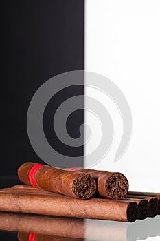 Different cigars on a glass table