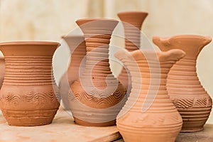 Different clay pots on a wooden table