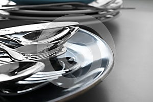 Different clean kitchenware on light grey table, closeup. Space for text