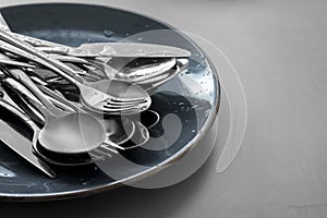 Different clean kitchenware on light grey table. Space for text