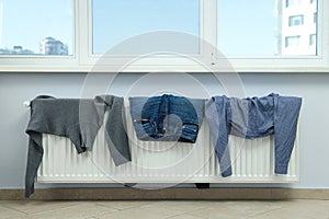 Different clothes drying on a radiator indoor