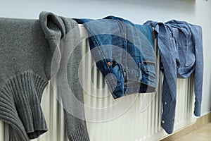 Different clothes drying on a radiator indoor