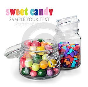 Different color candy and gum in glass jars