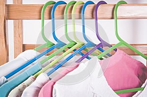 Different color clothes t-shirts on the rack