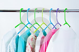 Different color clothes t-shirts on the rack
