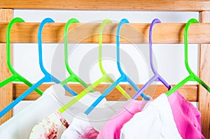 Different color clothes t-shirts on the rack