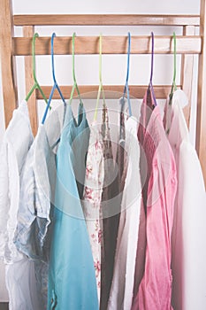 Different color clothes t-shirts on the rack