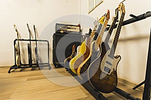 different color guitars, amplifiers and loudspeakers in the music studio