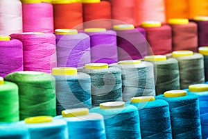 Different color spools of thread for the textile industry