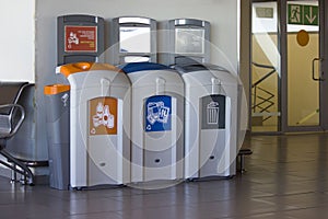 Different Colored Bins For Collection Of Recycle Materials in airport.