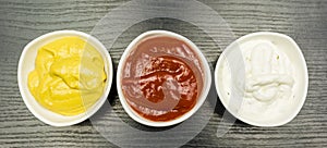 Colorful dips. Garlic sauce, ketchup and mustard. View from above.